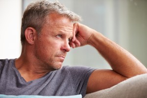Man looking out into distant clearly suffering from some internal pain